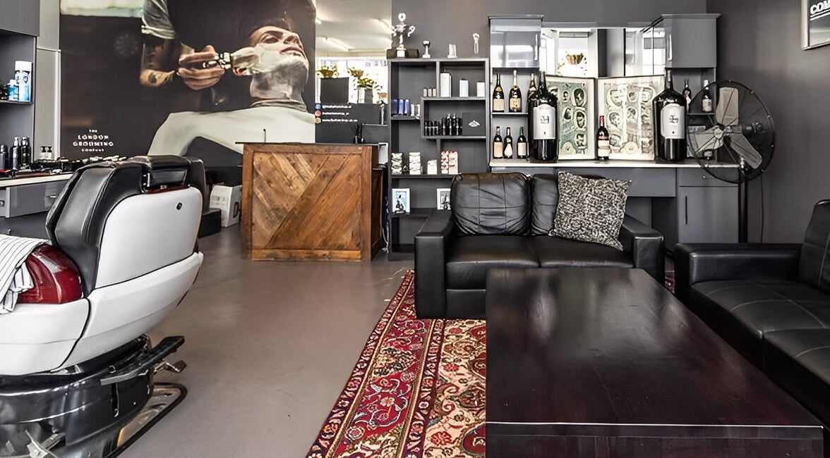 Spacious lounge at The Barberchop in Cape Town, Western Cape, ZA, featuring modern barber chairs and decor.