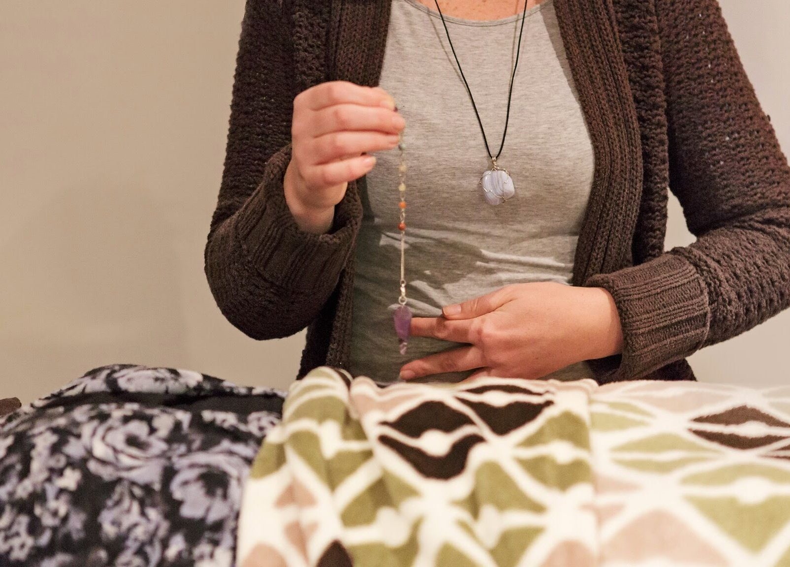 Reiki practitioner using pendulum at Healing With Dawn, Collingwood, Ontario, CA.