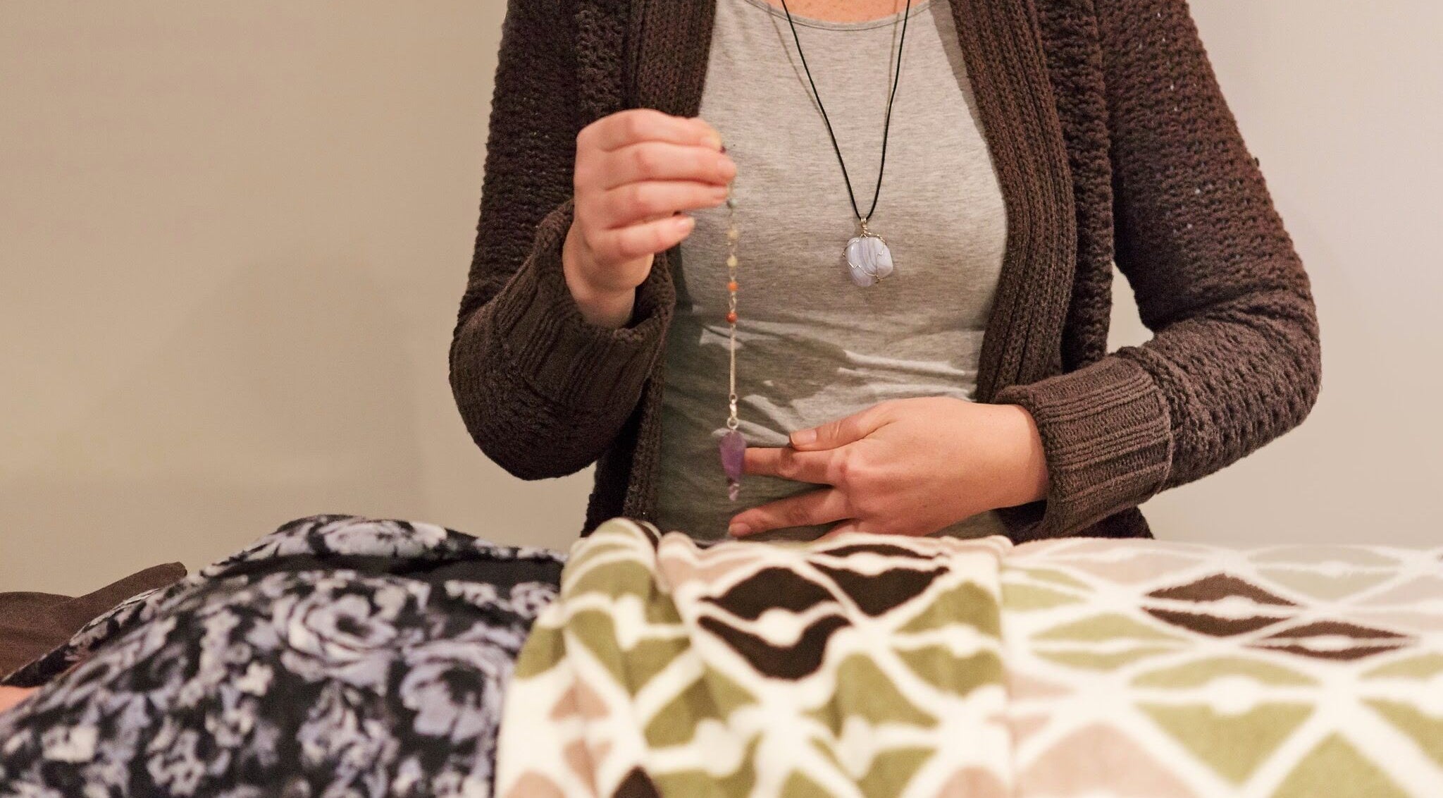 Reiki practitioner using pendulum at Healing With Dawn, Collingwood, Ontario, CA.