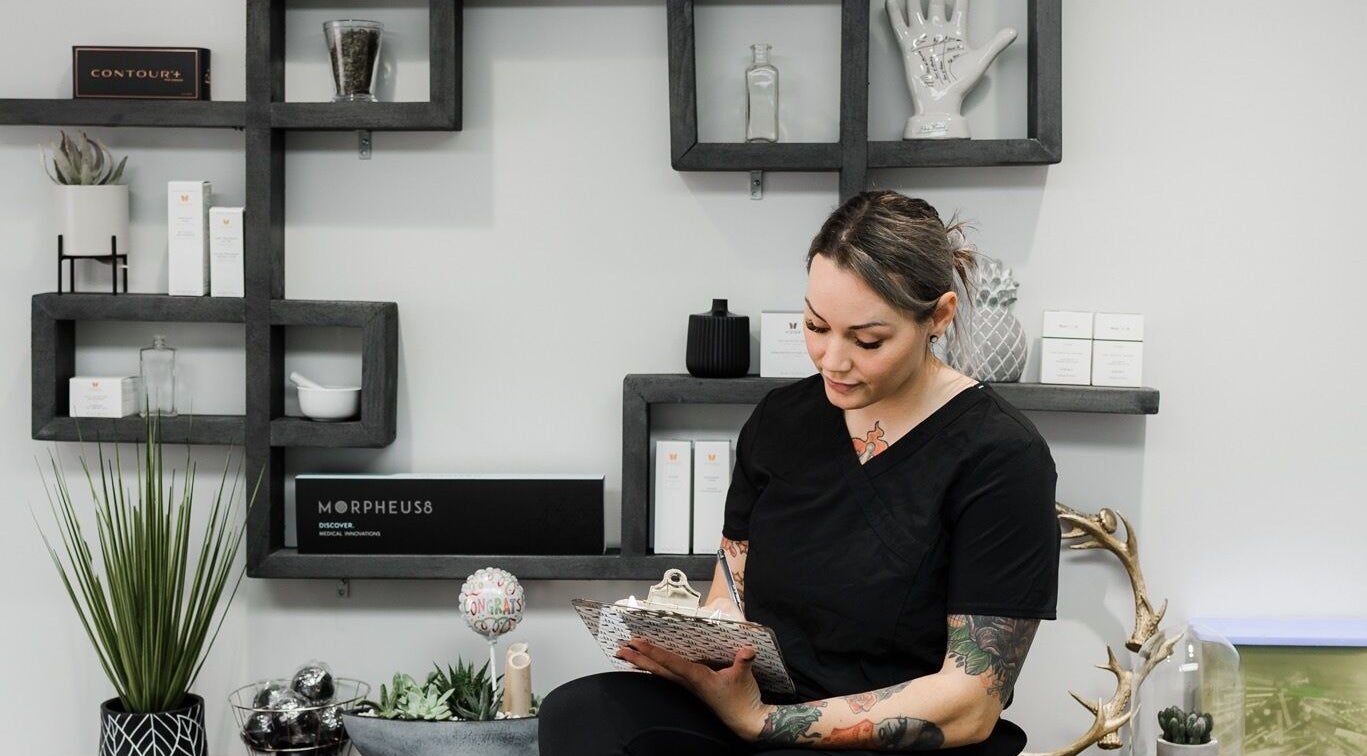 Staff member at Jem Medical Strathroy - Dose of Elegance in Strathroy, Ontario, CA sitting by modern decor.