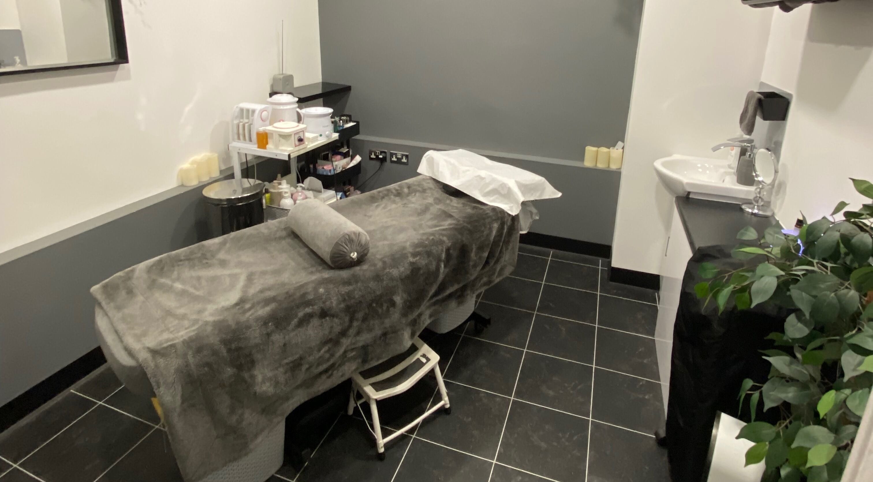 Relaxing treatment room at Beauty Boutique, Newquay, England, GB with spa bed and calming decor.
