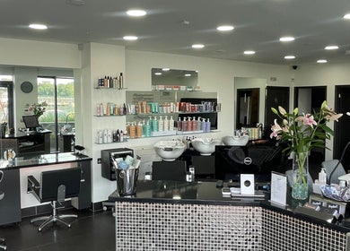 Modern salon interior at Vaughan's Hair and Beauty in Plymouth, England, GB with sleek styling stations.