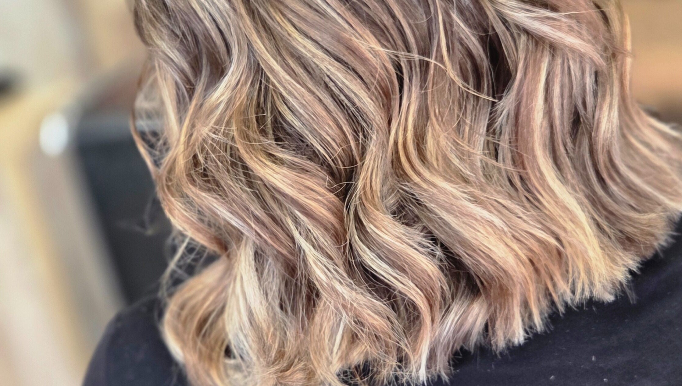 Close-up of wavy blonde hair styled at MB Hairdressing Based at Cheryl's Barbers, Barnsley, England, GB.