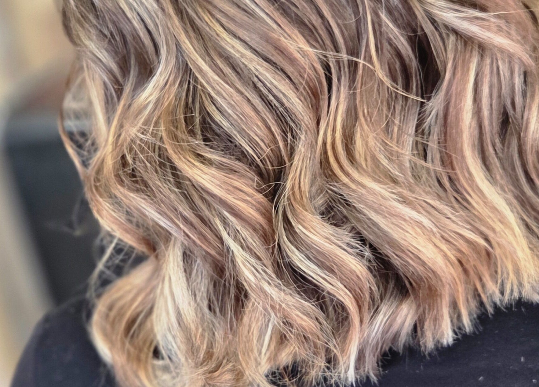 Close-up of wavy blonde hair styled at MB Hairdressing Based at Cheryl's Barbers, Barnsley, England, GB.