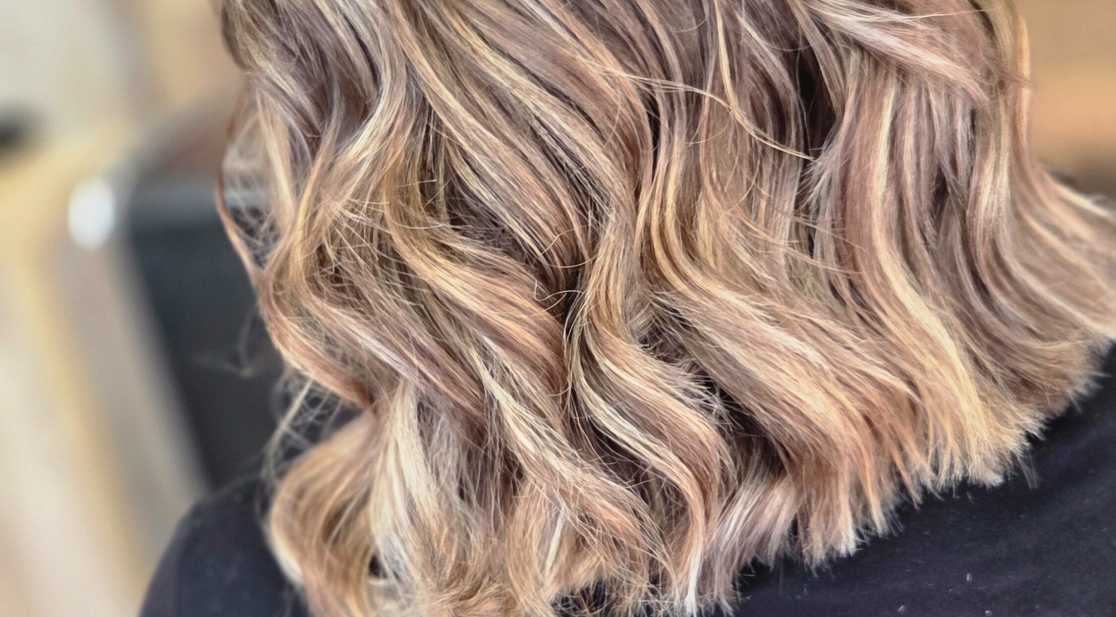 Close-up of wavy blonde hair styled at MB Hairdressing Based at Cheryl's Barbers, Barnsley, England, GB.