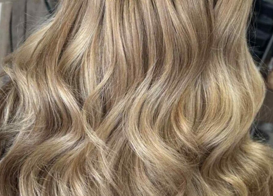 Flowing blonde waves styled at MB Hairdressing in Cheryl's Barbers, Barnsley, England. Perfect salon look.