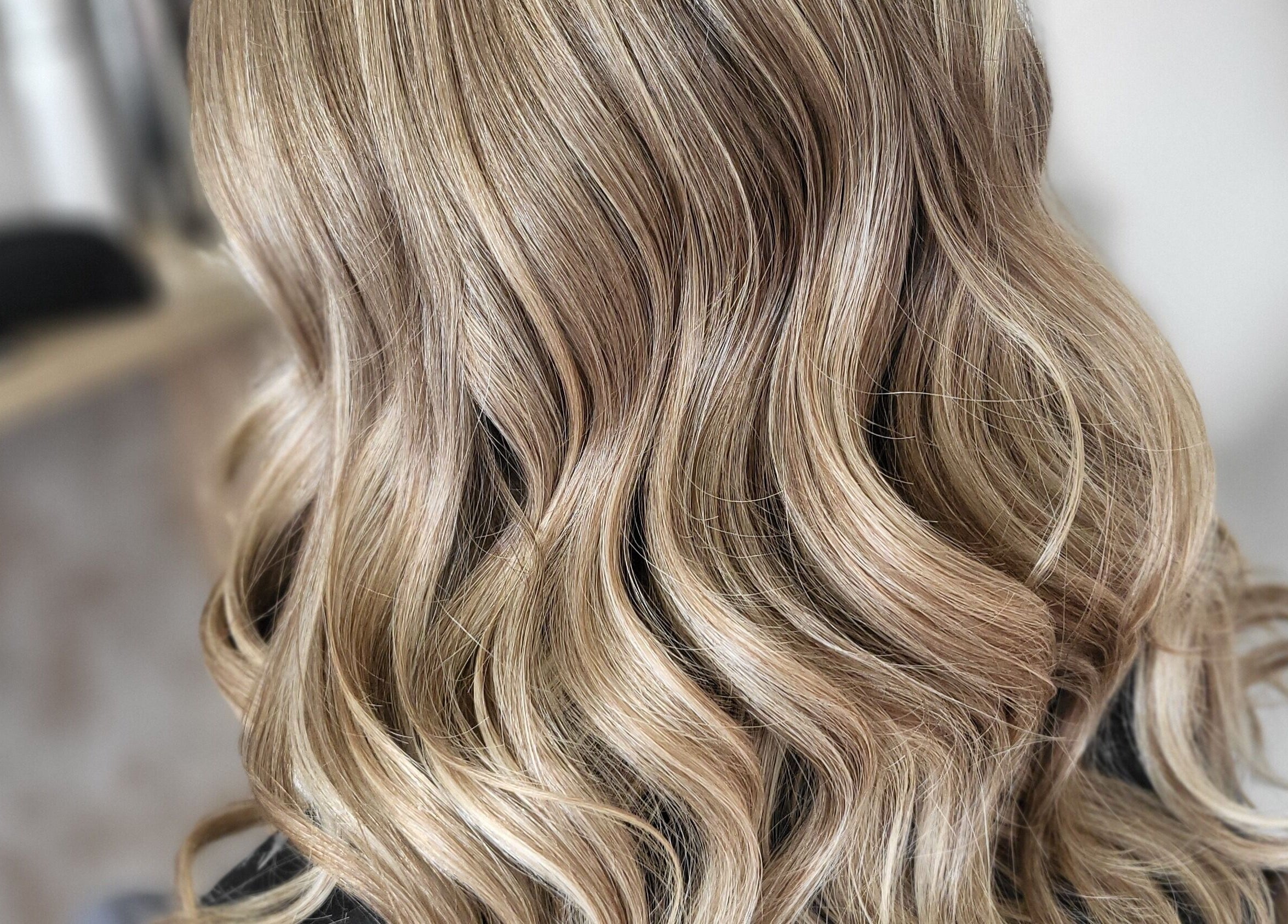 Blonde curls styled expertly at MB Hairdressing, Cheryl's Barbers in Barnsley, England, GB.
