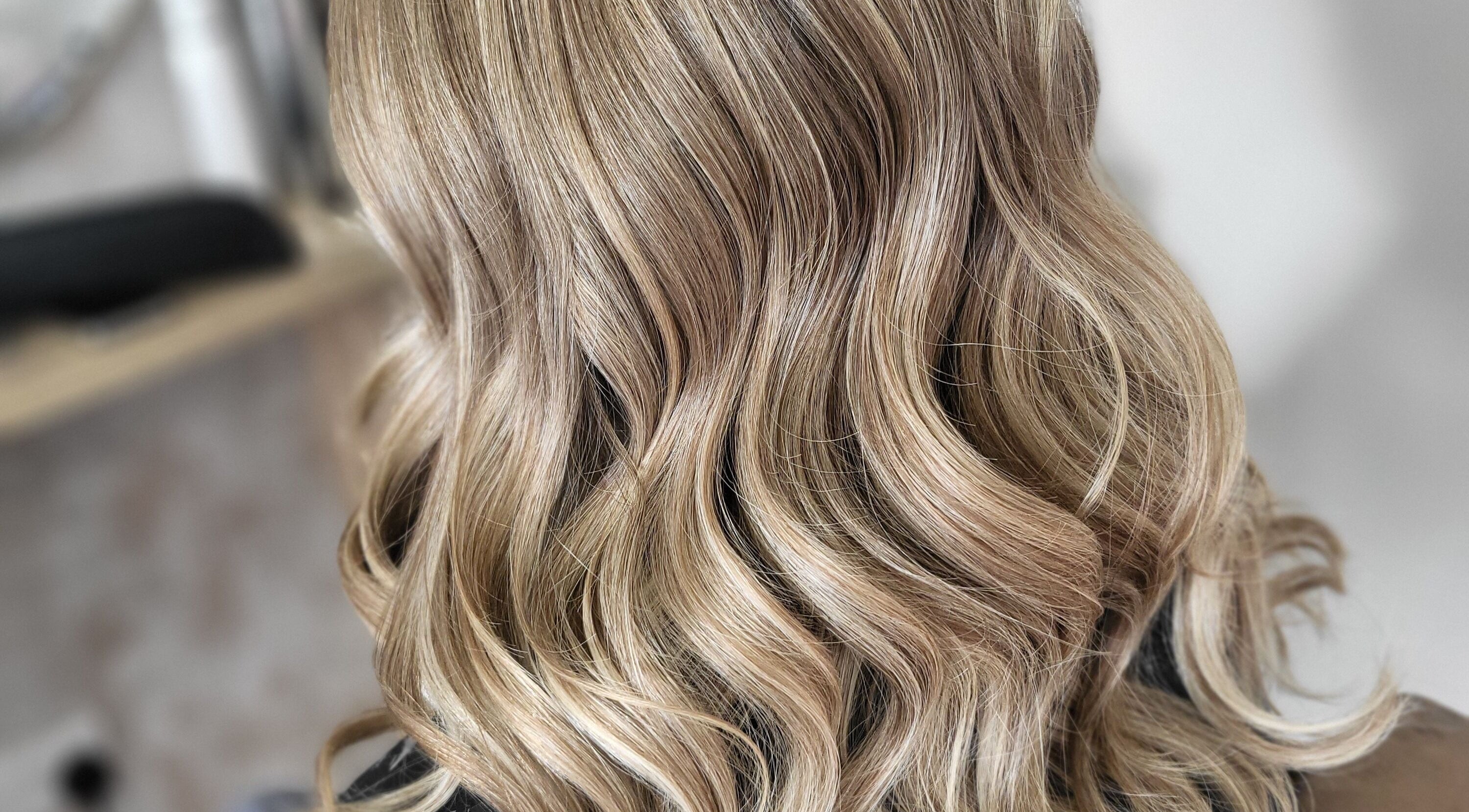 Blonde curls styled expertly at MB Hairdressing, Cheryl's Barbers in Barnsley, England, GB.