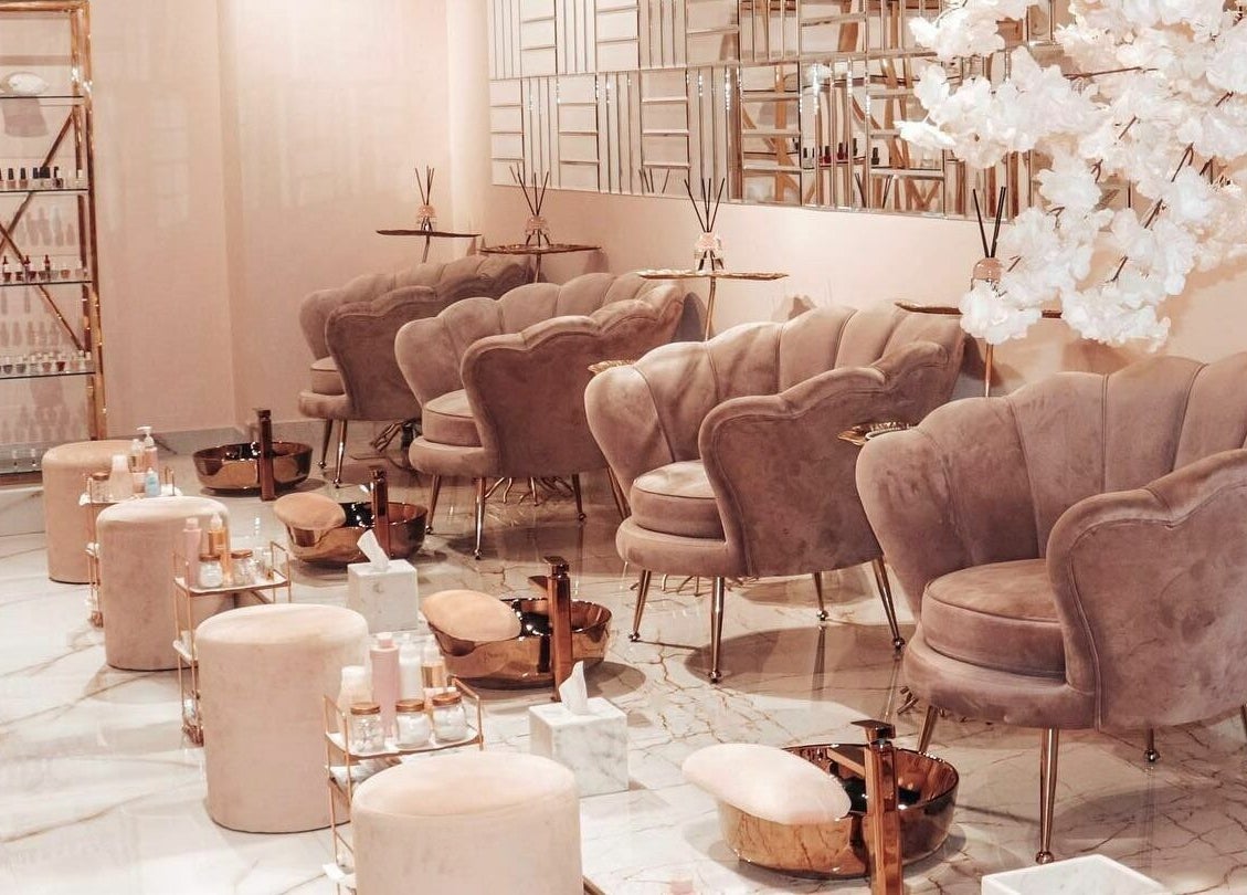 Elegant seating area at Yasna Beauty Salon, Dubai, AE, featuring plush chairs and chic decor.