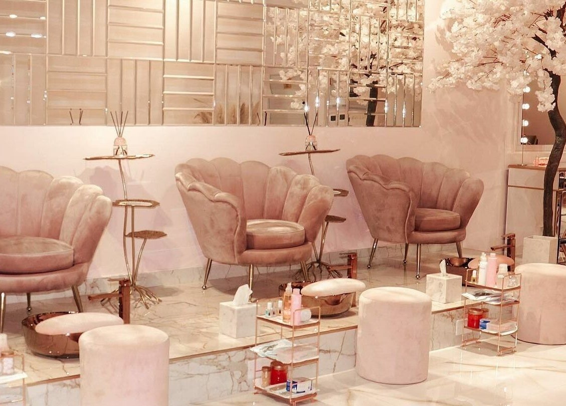 Luxurious interior of Yasna Beauty Salon in Dubai, AE with plush seating and ambient decor.