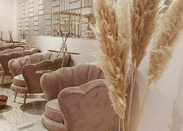 Chic seating and decor at Yasna Beauty Salon, offering relaxation in Dubai, AE.