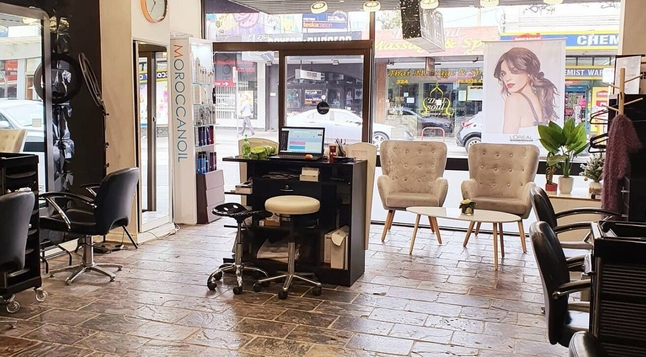 Interior of Hair Keen salon in Melbourne, Victoria, AU features stylish chairs and a central styling station.