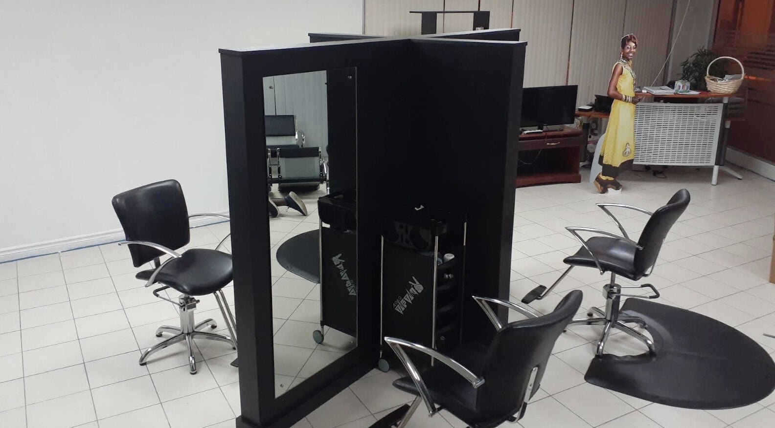 Modern salon setup at Le Monde De Paula Ltd - LMDPHAIRCARETT, Port of Spain, TT features sleek chairs and mirrors.