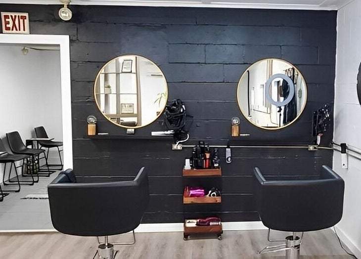 Mav & Harp Co Salon in Selinsgrove, Pennsylvania, US showcases a modern styling area with two mirrors and chairs.
