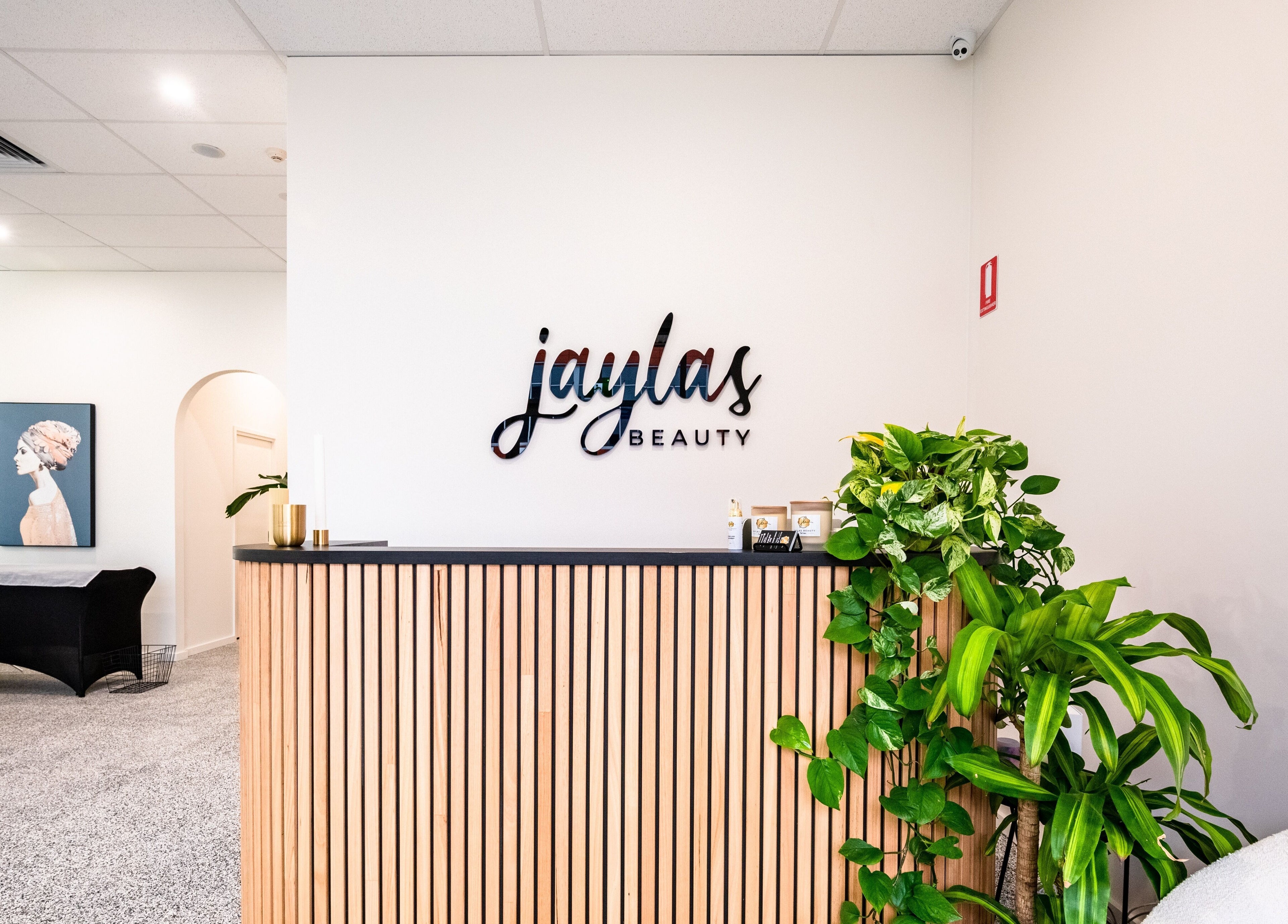 Elegant reception area of Jayla's Beauty Salon, Melbourne, Victoria, AU with lush plants and stylish decor.