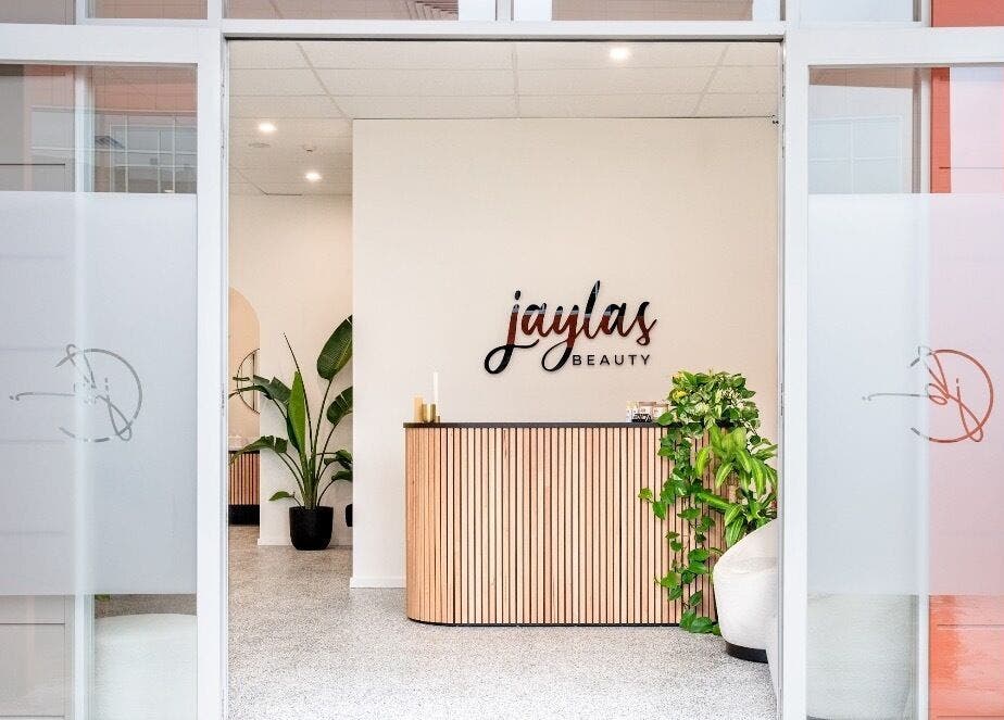 Entrance of Jayla's Beauty Salon, Melbourne, Victoria, AU, showcasing a stylish reception area with plants.