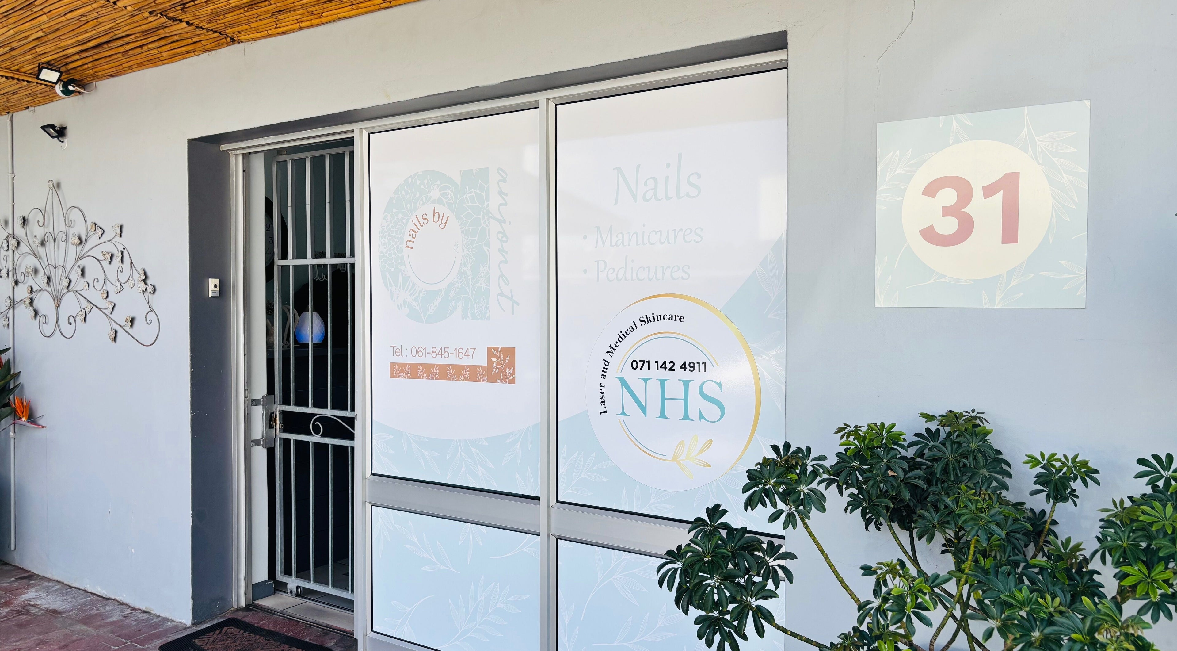 Front of Nails by Anjonet, George, Western Cape, ZA with elegant signage and lush plants.