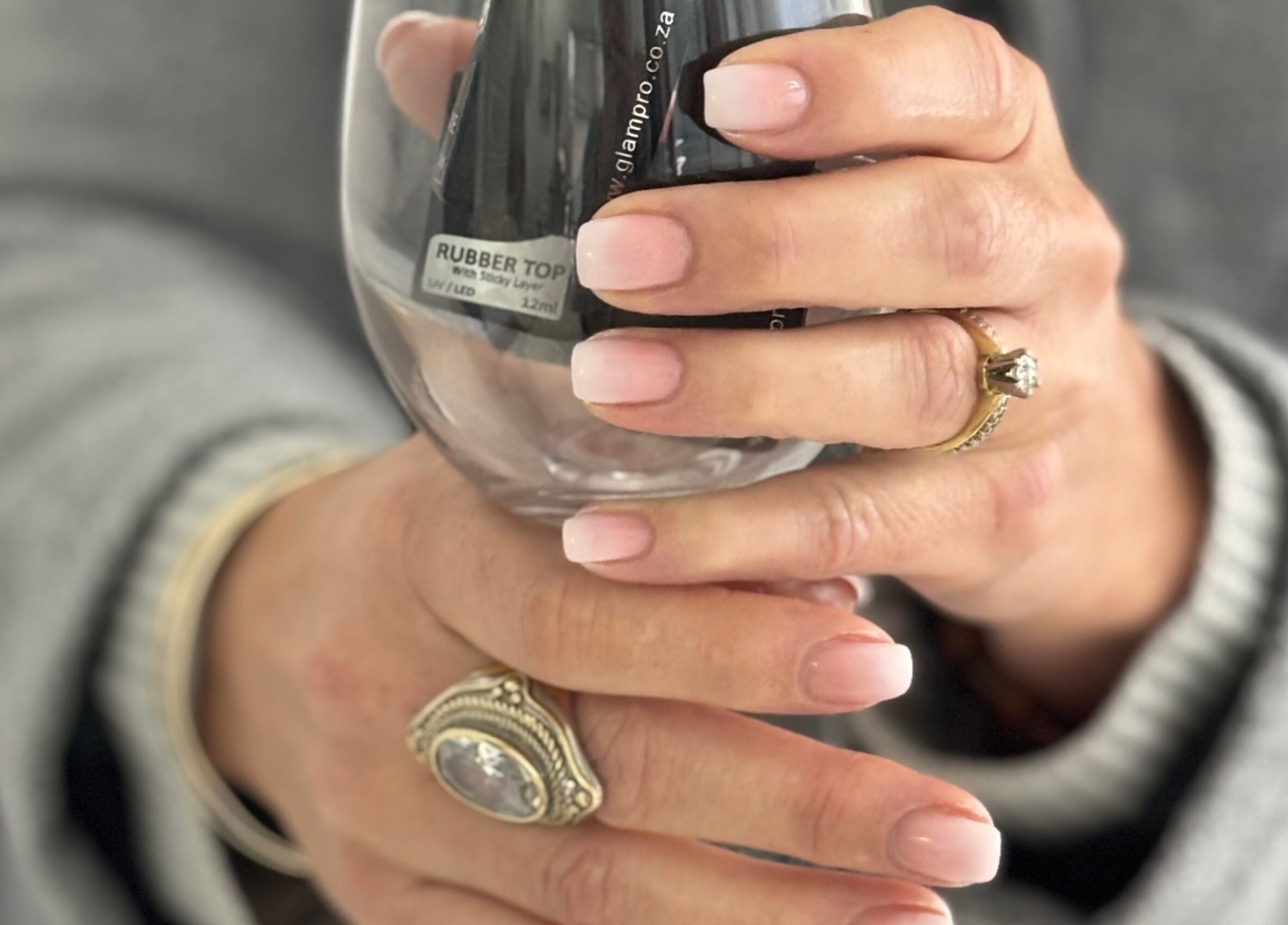 Elegant nude nails holding a glass at Nails by Anjonet, George, Western Cape, ZA.