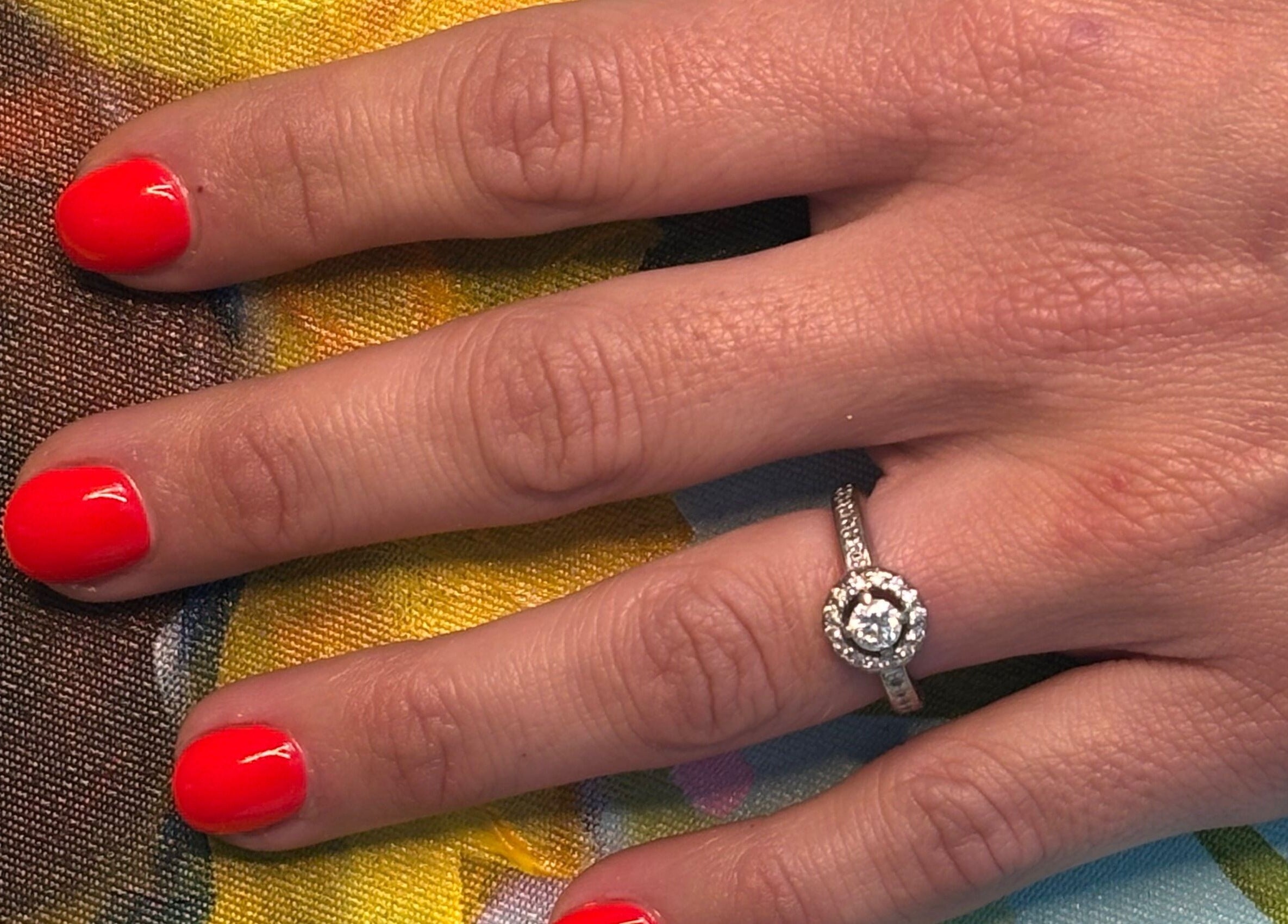 Vibrant red nails with a diamond ring at Nails by Anjonet, George, Western Cape, ZA.