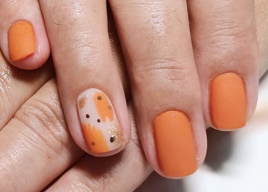 Beautiful orange nail art at Beauty by Nadia, Pretoria, Gauteng, ZA, showcasing vivid autumn hues.