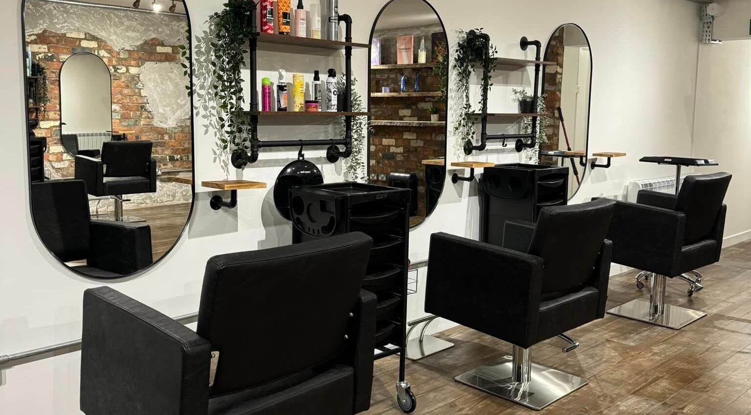 Elegant interior of Matthew Powell Hairdressing - Solo Studio, Prestatyn, Wales, GB with modern salon chairs and mirrors.