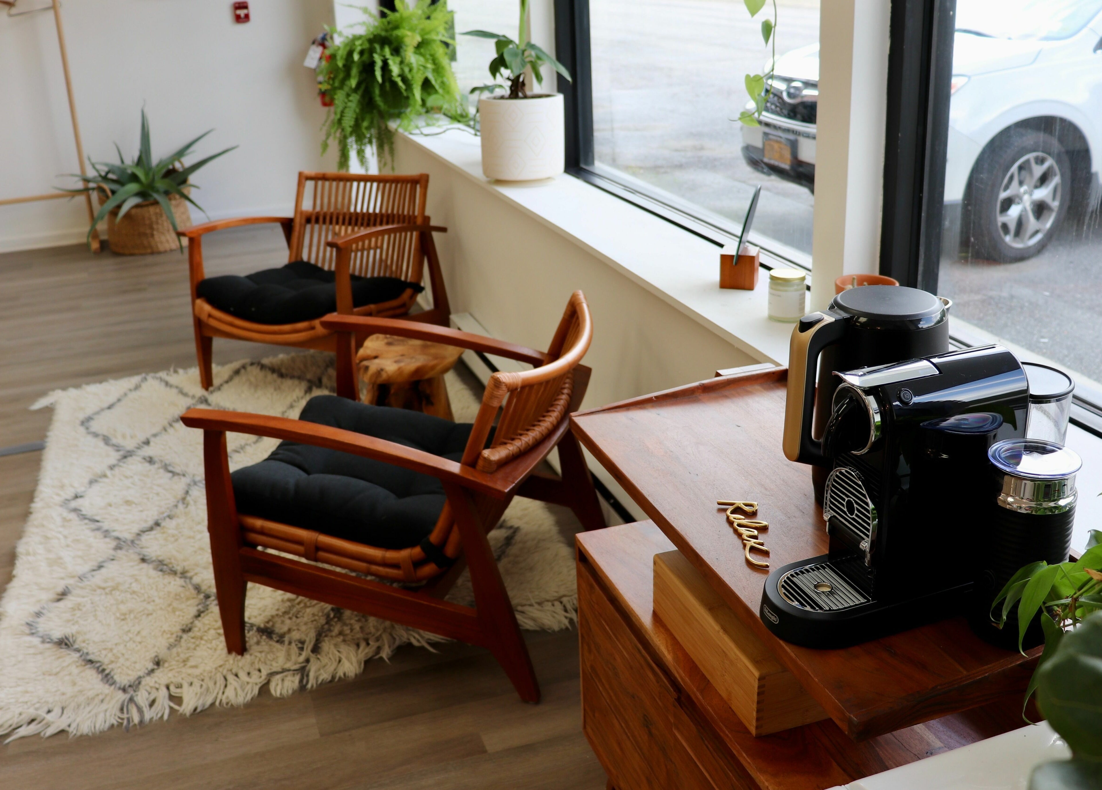 Inviting lounge at Roots Radicals North, Brewster, New York, US with wooden chairs and coffee setup.