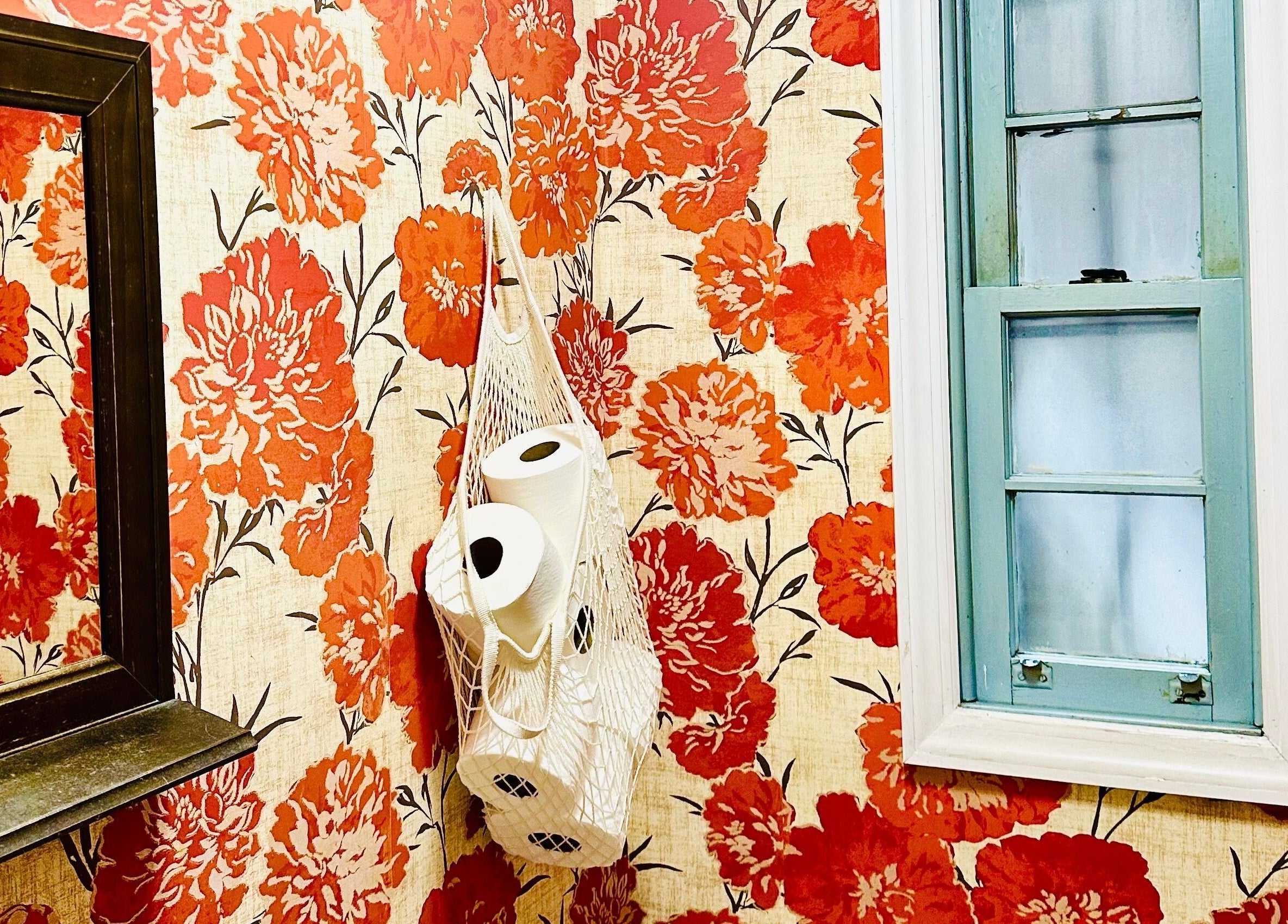 Bold floral wallpaper with blue window at Roots Radicals Salon, New York, New York, US.
