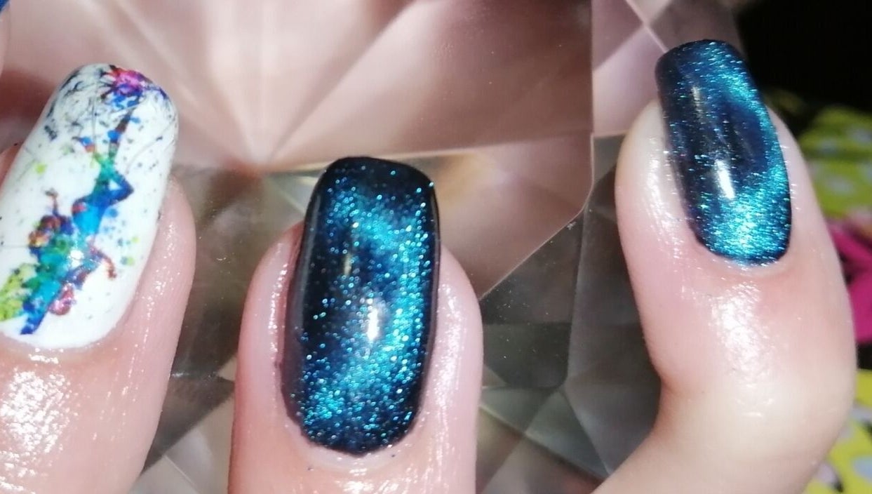 Vibrant cosmic nail art at Nailed It Nerize in Pretoria, Gauteng, ZA, showcasing blue and white designs.