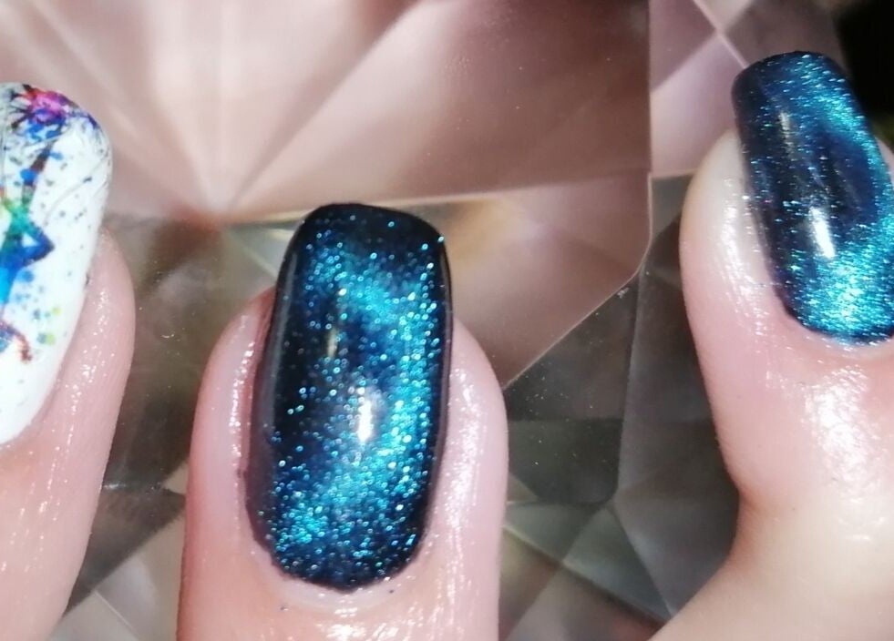 Vibrant cosmic nail art at Nailed It Nerize in Pretoria, Gauteng, ZA, showcasing blue and white designs.