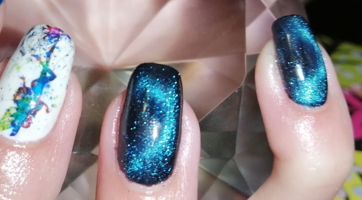 Vibrant cosmic nail art at Nailed It Nerize in Pretoria, Gauteng, ZA, showcasing blue and white designs.