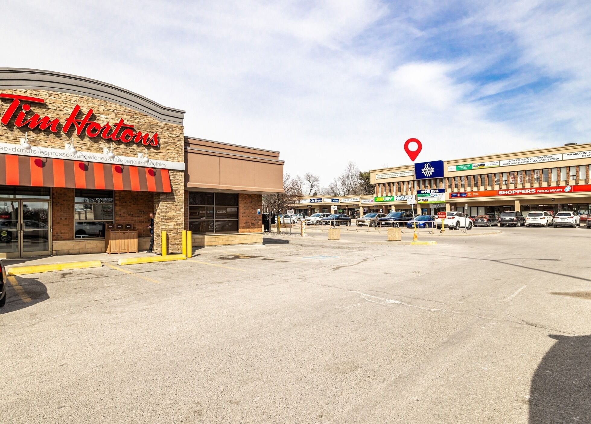Exterior view of A-Plus Rehab, Toronto, Ontario, CA near a shopping plaza.