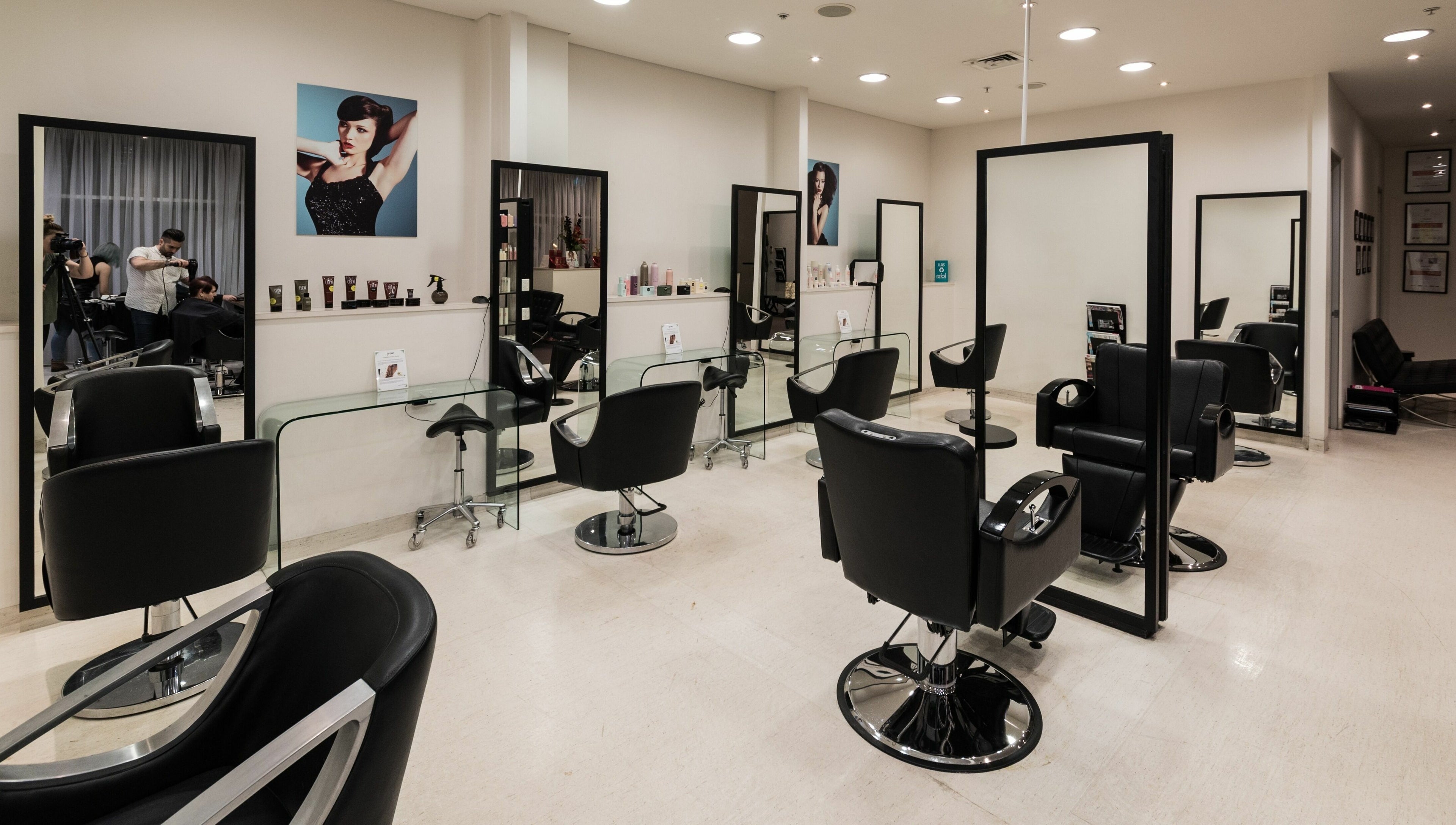 Spacious salon interior at Preen, Melbourne, Victoria, AU, featuring modern black styling chairs and large mirrors.