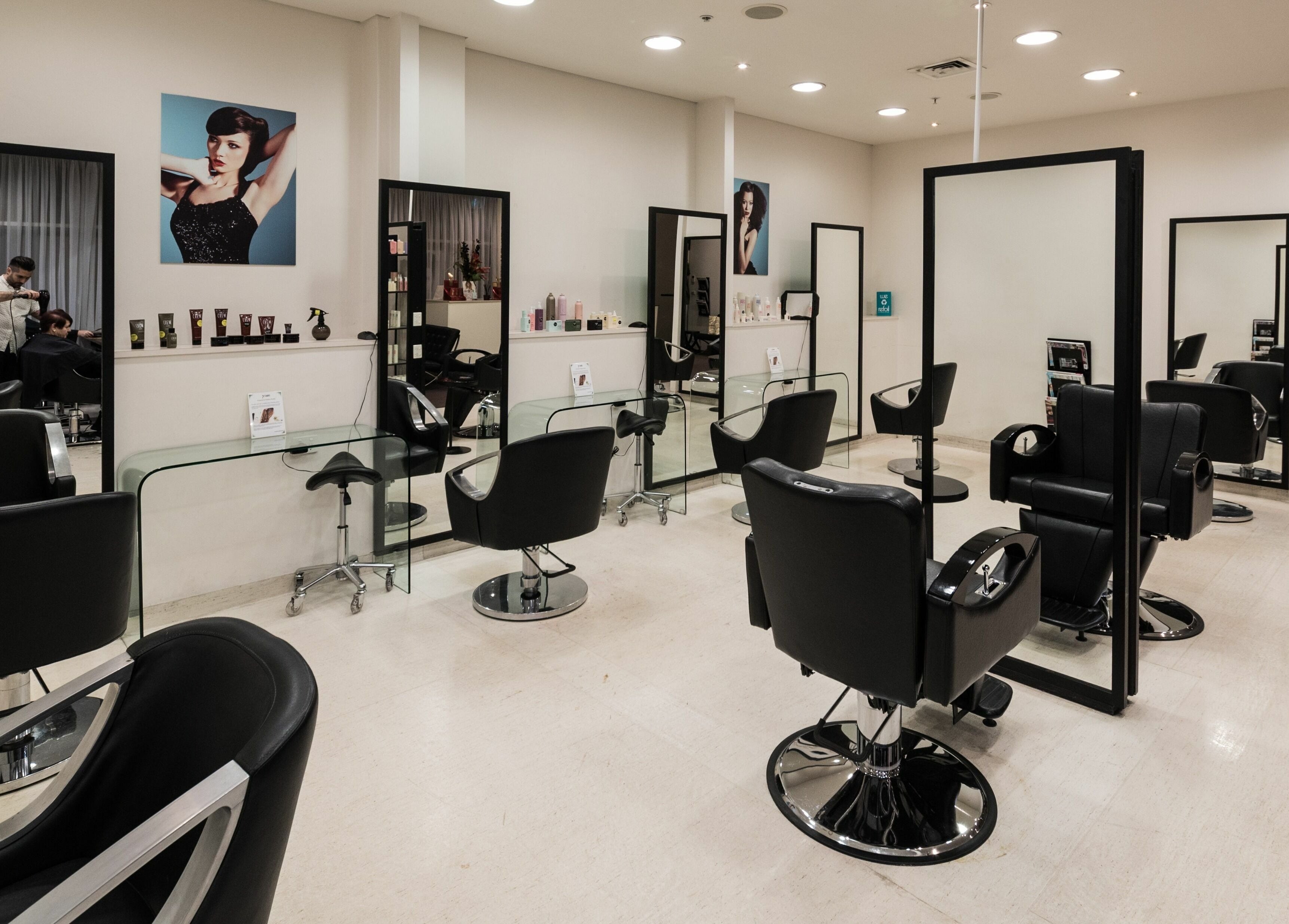 Spacious salon interior at Preen, Melbourne, Victoria, AU, featuring modern black styling chairs and large mirrors.