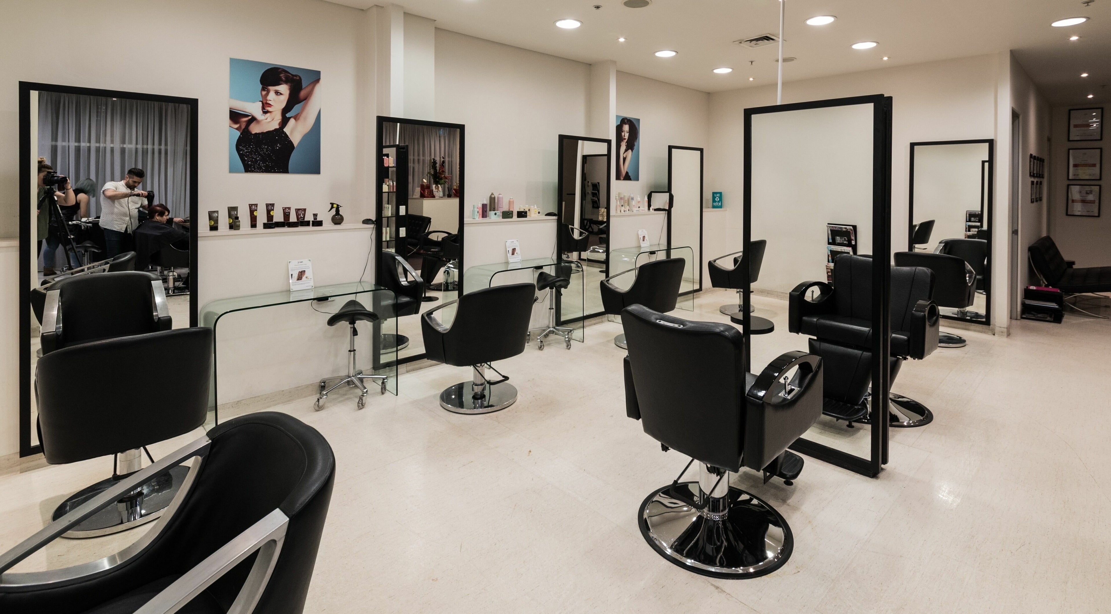 Spacious salon interior at Preen, Melbourne, Victoria, AU, featuring modern black styling chairs and large mirrors.
