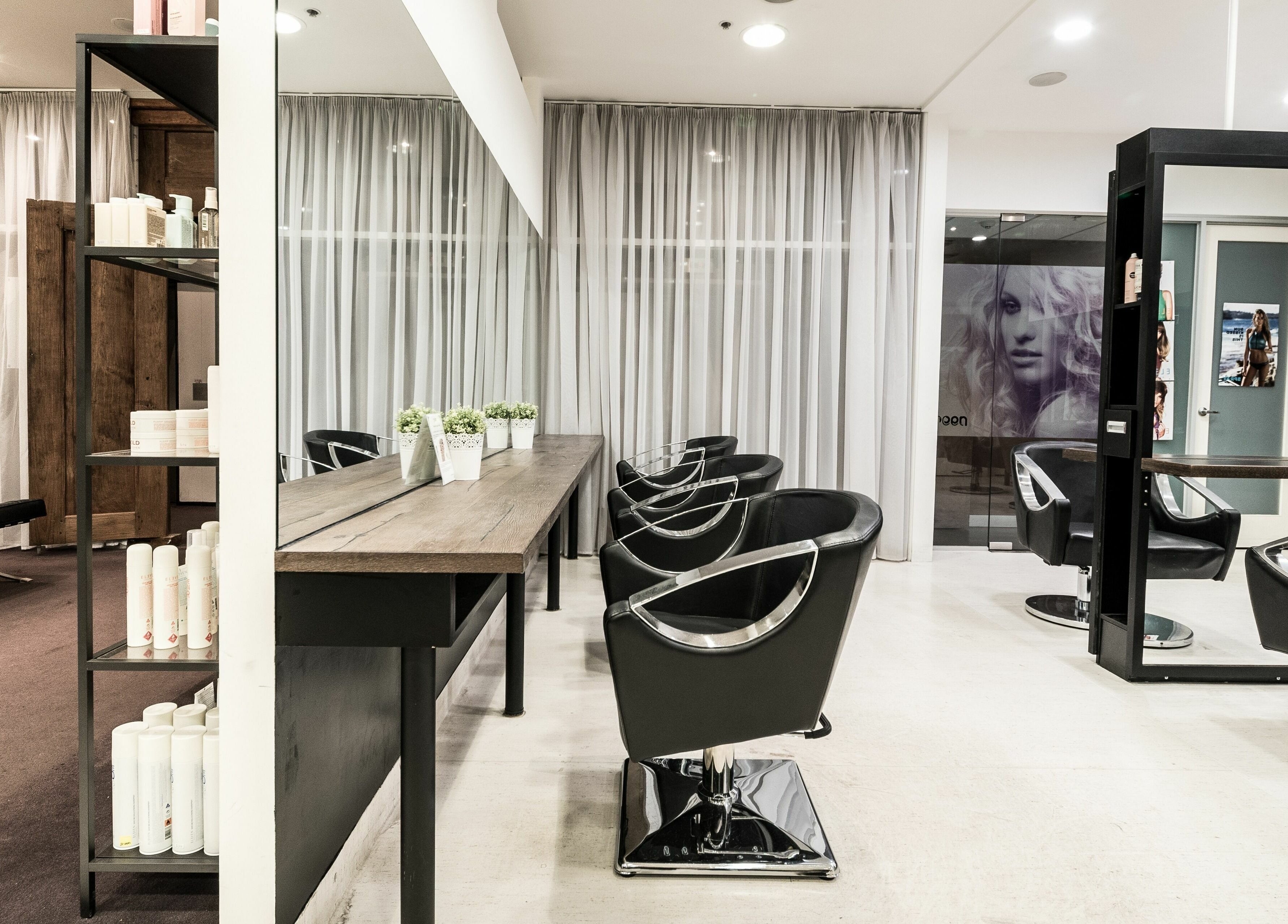 Modern salon interior at Preen, showcasing elegant styling chairs in Melbourne, Victoria, AU.
