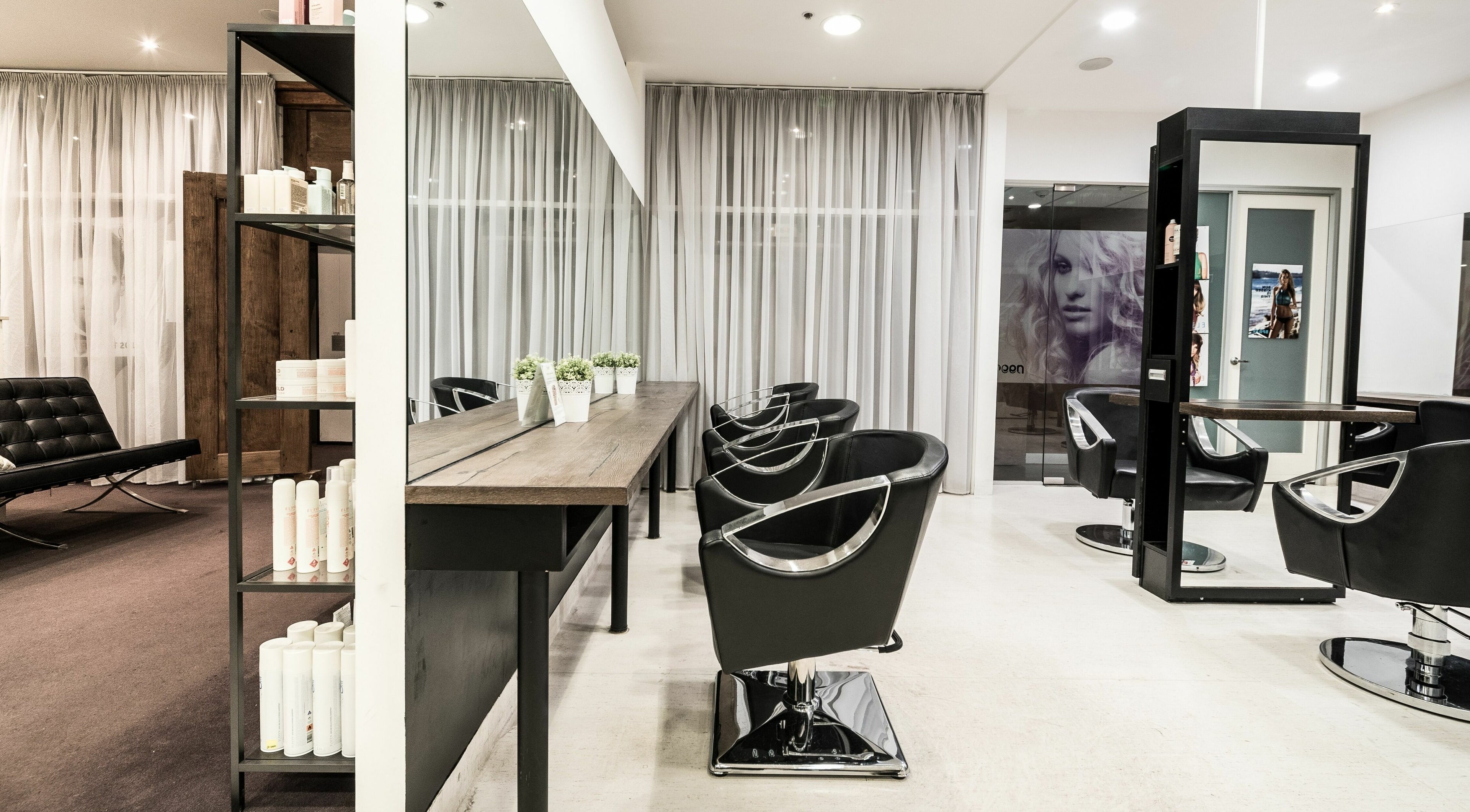 Modern salon interior at Preen, showcasing elegant styling chairs in Melbourne, Victoria, AU.