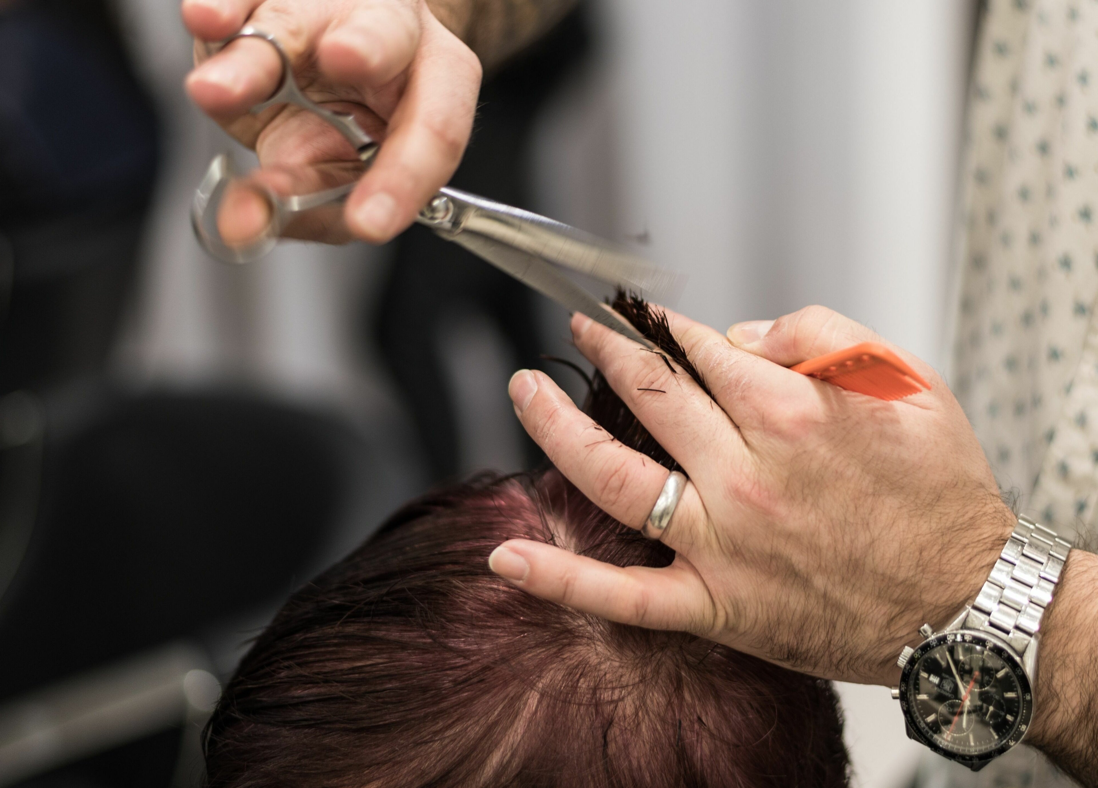 Expert haircut in progress at Preen, Melbourne, Victoria, AU. Scissors and comb crafting a stylish look.