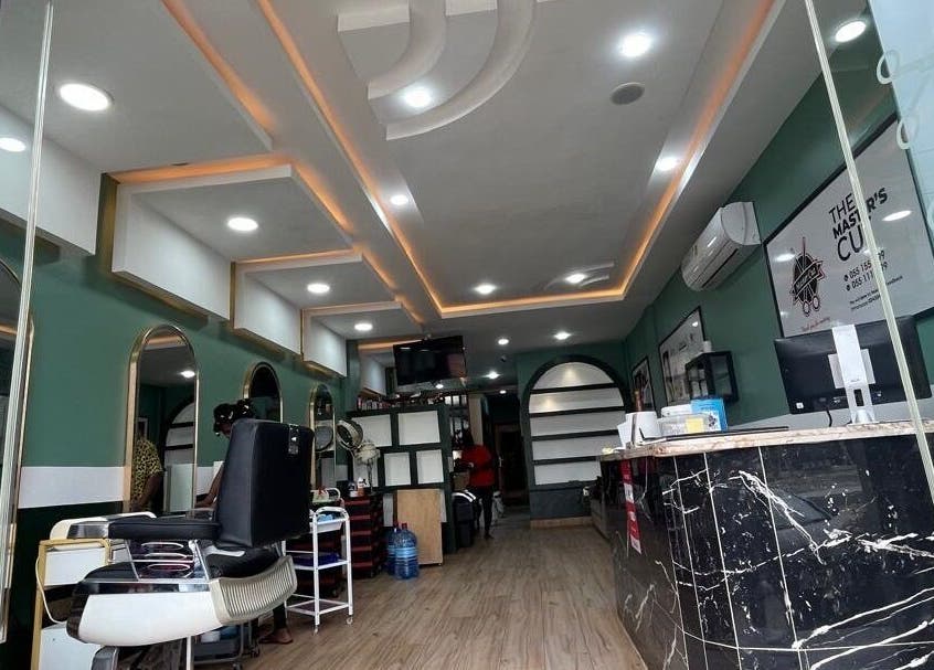 Modern interior of The Masters Cut Spintex in Accra, Greater Accra Region, GH with elegant salon chairs and decor.