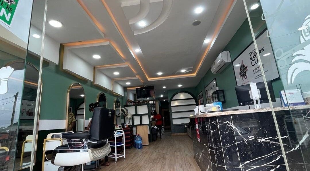 Modern interior of The Masters Cut Spintex in Accra, Greater Accra Region, GH with elegant salon chairs and decor.