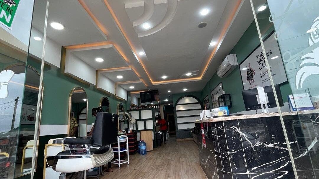 Modern interior of The Masters Cut Spintex in Accra, Greater Accra Region, GH with elegant salon chairs and decor.