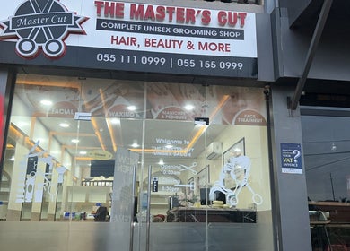 Front view of The Masters Cut Spintex salon in Accra, Greater Accra Region, GH showcasing glass doors and signage.