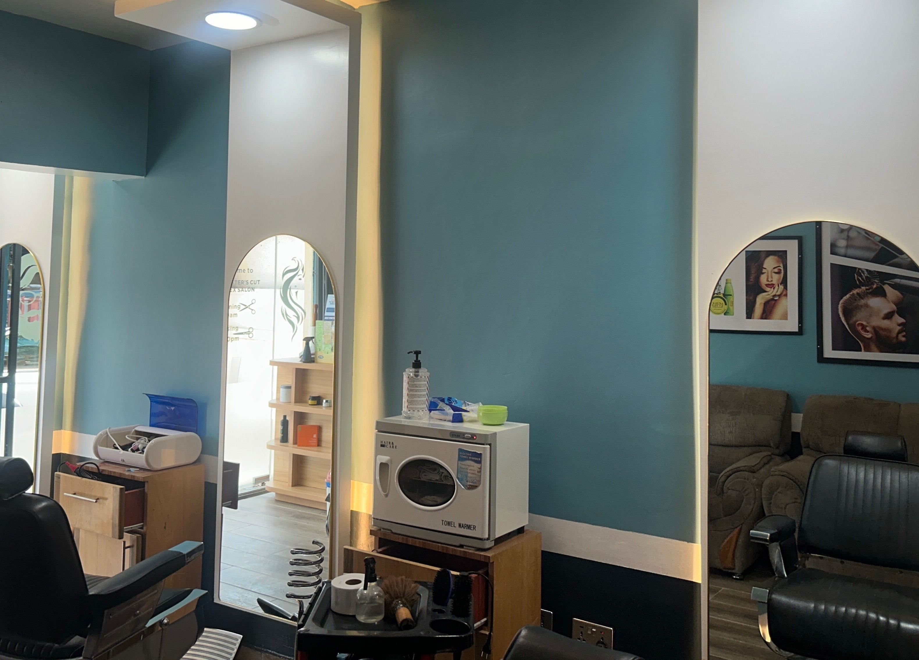 Modern salon interior at The Masters Cut Osu, Accra, Greater Accra Region, GH, featuring stylish mirrors and chairs.