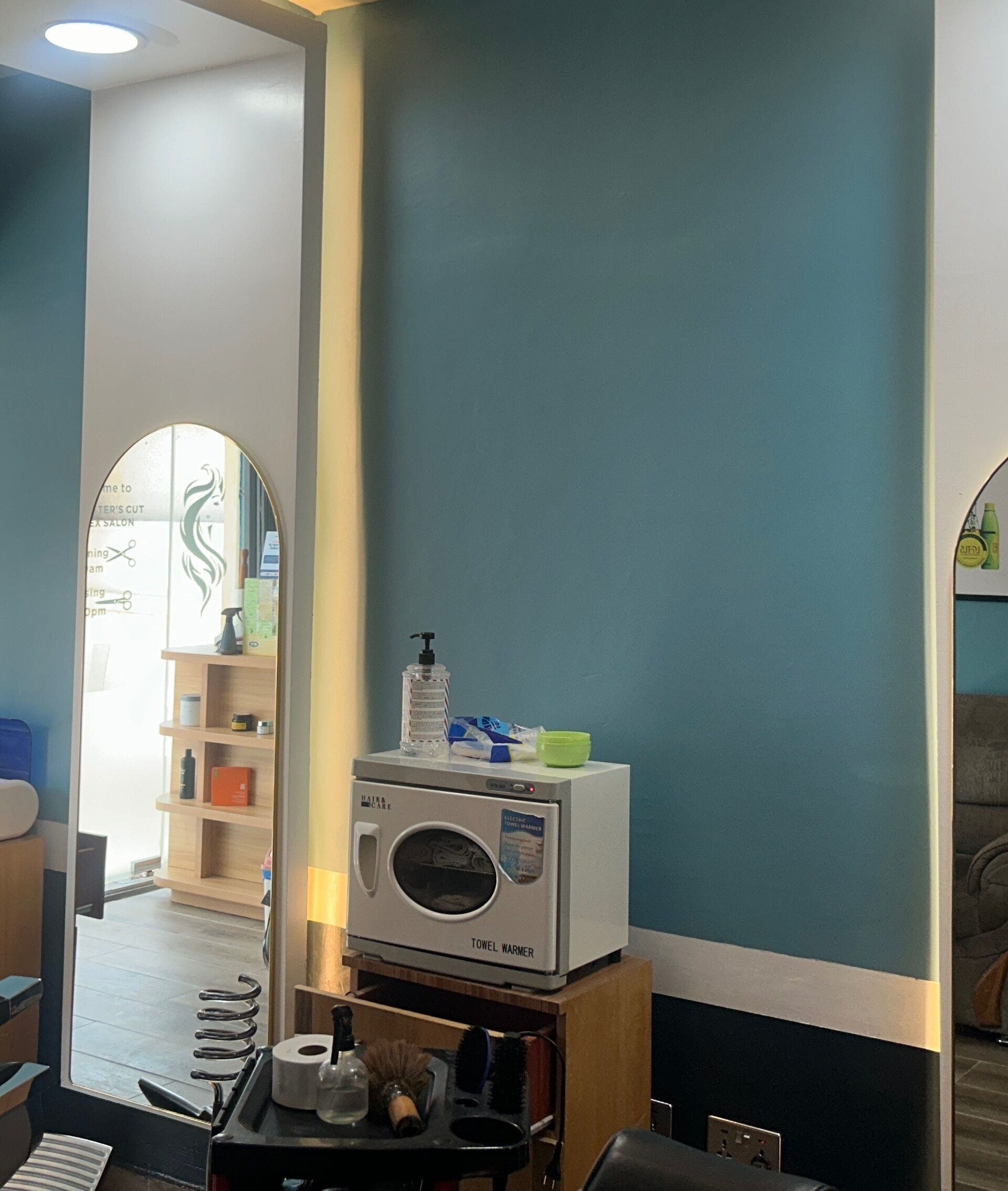 Modern salon interior at The Masters Cut Osu, Accra, Greater Accra Region, GH, featuring stylish mirrors and chairs.