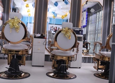 Luxurious salon chairs at The Masters Cut North Kaneshie, Accra, Greater Accra Region, GH, adorned with bows.