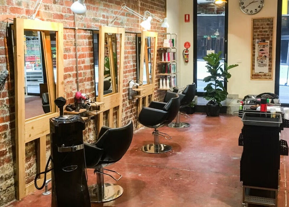Salon Atreve's sleek interior with styling chairs and mirrors in Melbourne, VIC, AU.