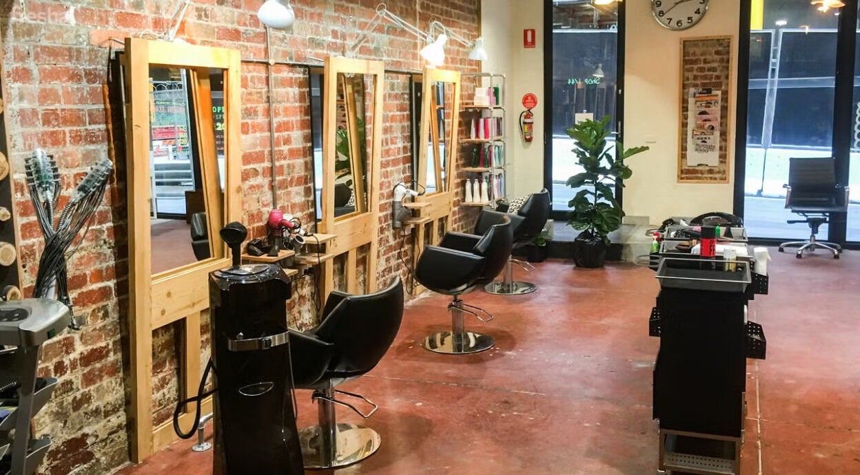 Salon Atreve's sleek interior with styling chairs and mirrors in Melbourne, VIC, AU.