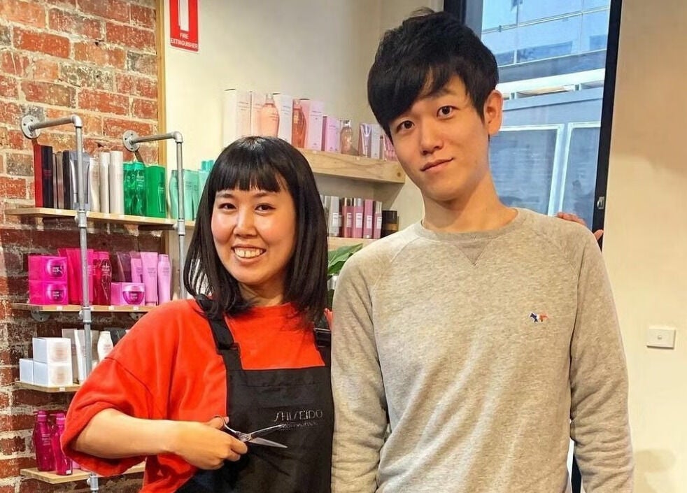 Friendly hairstylist and client at Salon Atreve in Melbourne, VIC, AU, showcasing a welcoming atmosphere.