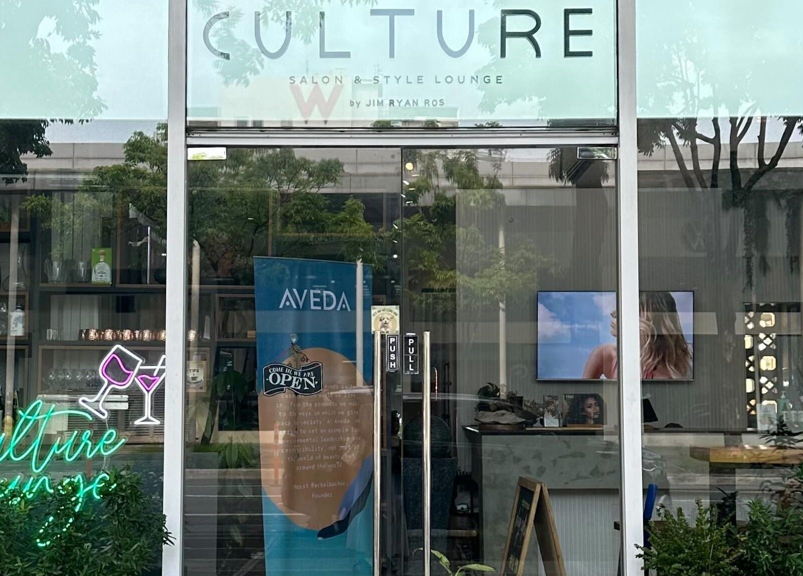 Front view of Culture Salon MNL, Taguig, Metro Manila, PH, showcasing glass facade and stylish interior decor.