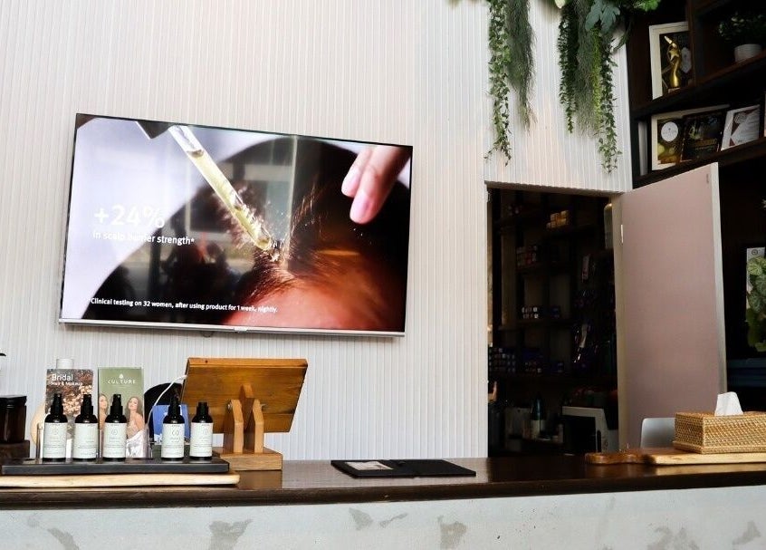 Reception area of Culture Salon MNL in Taguig, Metro Manila, PH, showcasing beauty products and decor.