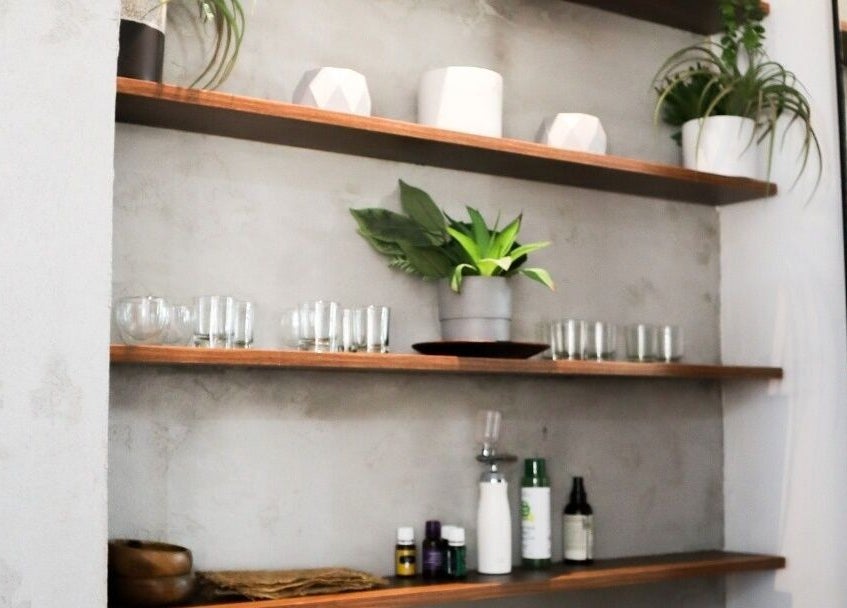 Modern minimalist shelves at Culture Salon MNL, Taguig, Metro Manila, PH, adorned with plants and glassware.